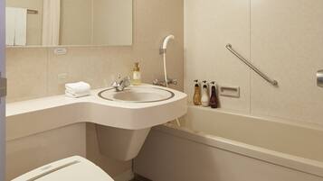 A modern bathroom with a toilet, sink, and shower.
