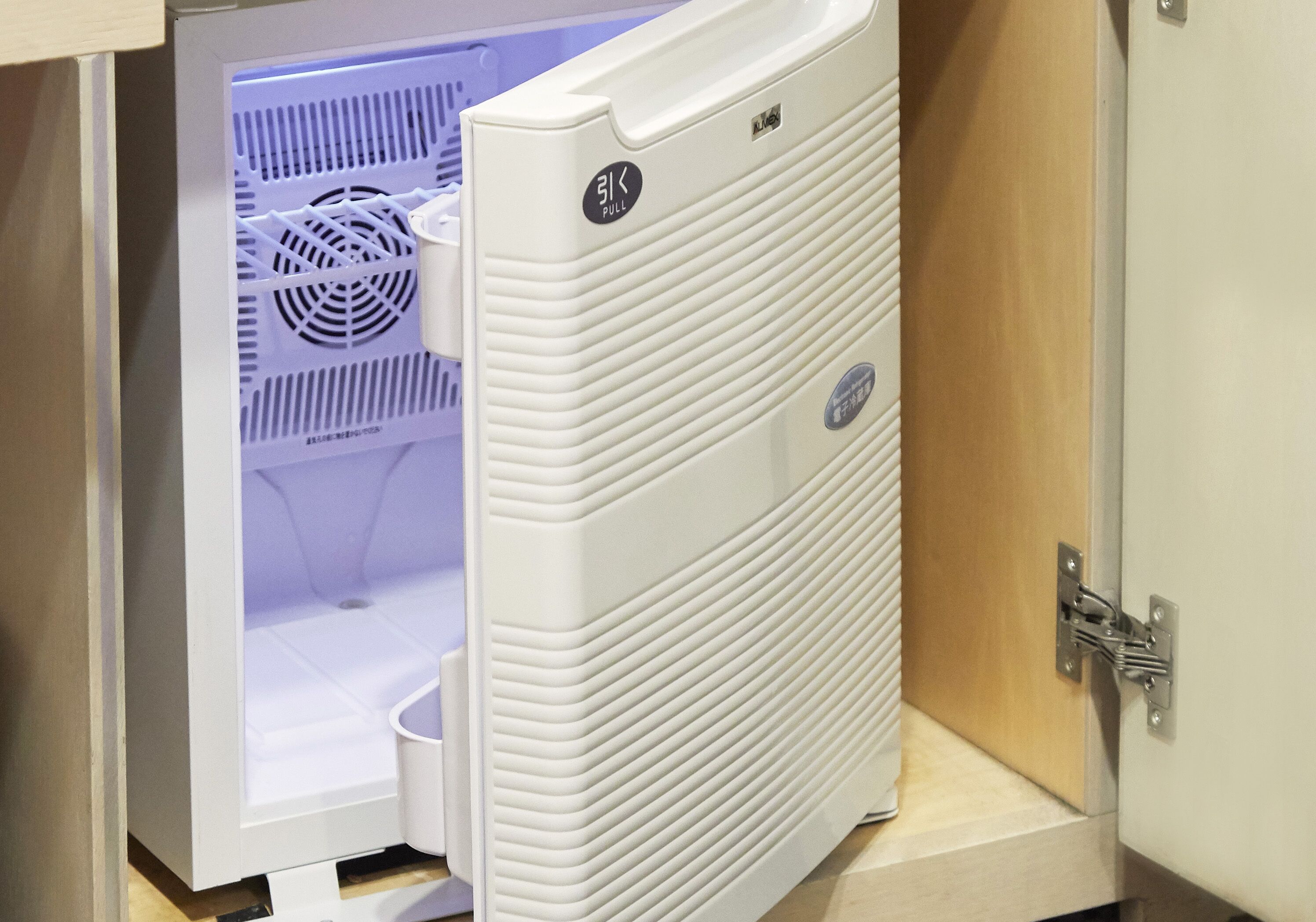 A white refrigerator with a pull handle and a small logo.