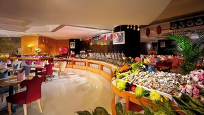 A hotel lobby with a buffet area, seating arrangements, and decorative elements. - Harbour Plaza Resort City (Yuen Long)