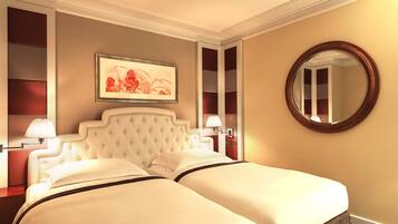A hotel room with a large bed, a round mirror, and a framed picture on the wall.