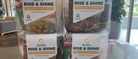 Four packages of 'Quality Rise & Shine Breakfast Favourites' in recyclable packaging.