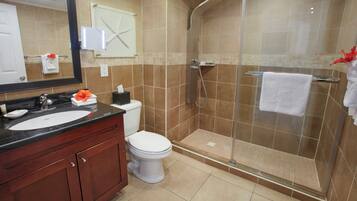 A bathroom with a sink, toilet, and shower.