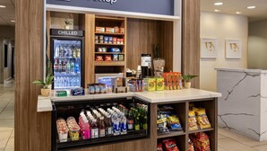 A shop with chilled beverages, snacks, and a variety of packaged goods. - Hilton Garden Inn Phoenix Airport (Phoenix)