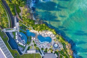 An aerial view of a resort with multiple swimming pools, a beach area, and lush greenery. - The Ritz-Carlton O‘ahu, Turtle Bay (Kahuku)