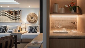 A modern living room with a sofa, coffee table, and decorative wall art.