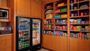 A vending area with snack and drink options, including microwaves and a refrigerator.