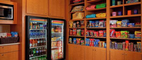 A vending area with snack and drink options, including microwaves and a refrigerator.
