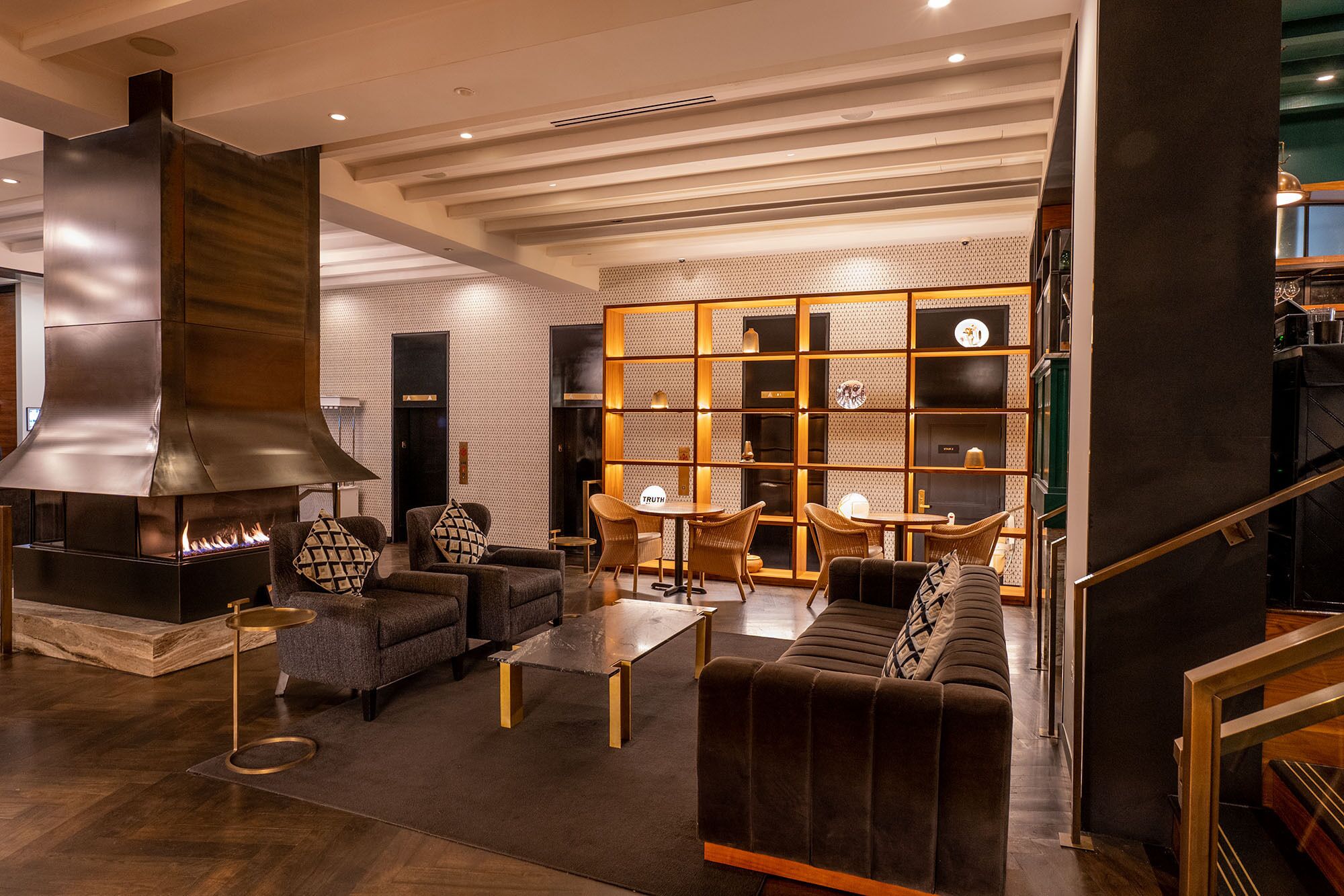 A modern living room with a fireplace, sofas, and a coffee table.