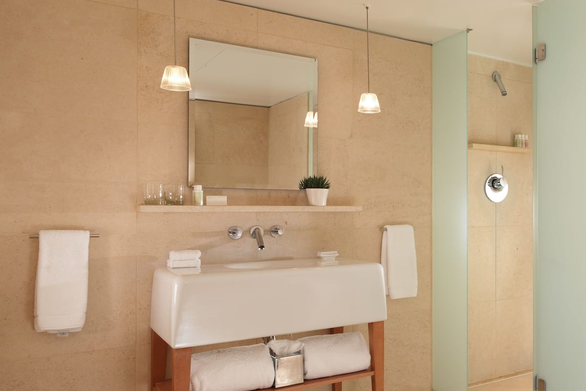 Designer toiletries, hair dryer, bathrobes, slippers