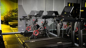 A gym with stationary bikes, treadmills, and weight machines.
