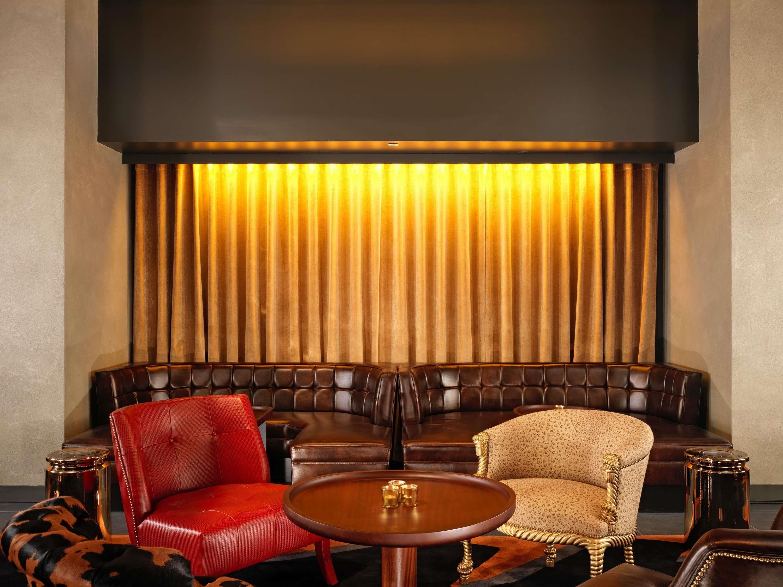 A seating area with a sofa, armchairs, and a round table.