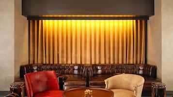 A seating area with a sofa, armchairs, and a round table.
