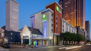 A Holiday Inn Express building with a modern design, located in an urban area with tall surrounding buildings. - Holiday Inn Express New Orleans Downtown by IHG (New Orleans)