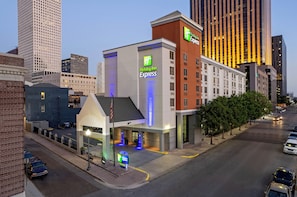 A Holiday Inn Express hotel with a modern facade, located in an urban setting with tall buildings nearby. - Holiday Inn Express New Orleans Downtown by IHG (New Orleans)