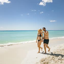 On the beach, white sand, beach cabanas, beach umbrellas