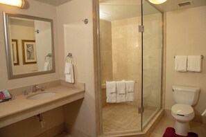 A bathroom with a sink, mirror, and toilet. - Courtyard by Marriott Erie (Erie)
