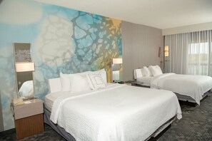 A hotel room with two beds, a large abstract mural on the wall, a desk with a lamp, and a window with curtains. - Courtyard by Marriott Erie Ambassador Conference Center (Erie)