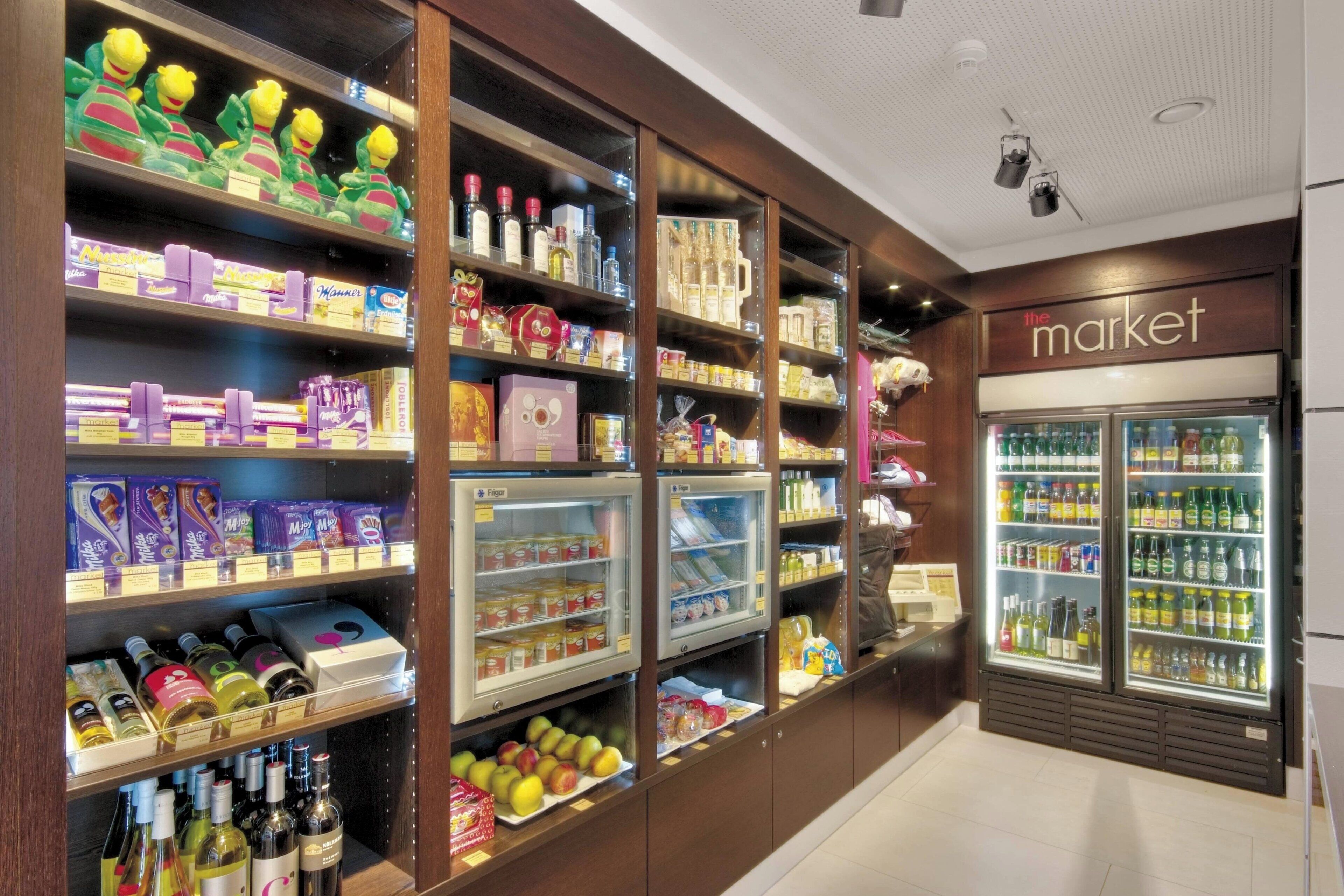 A well-organized grocery store with multiple refrigerated sections and shelves stocked with various products.