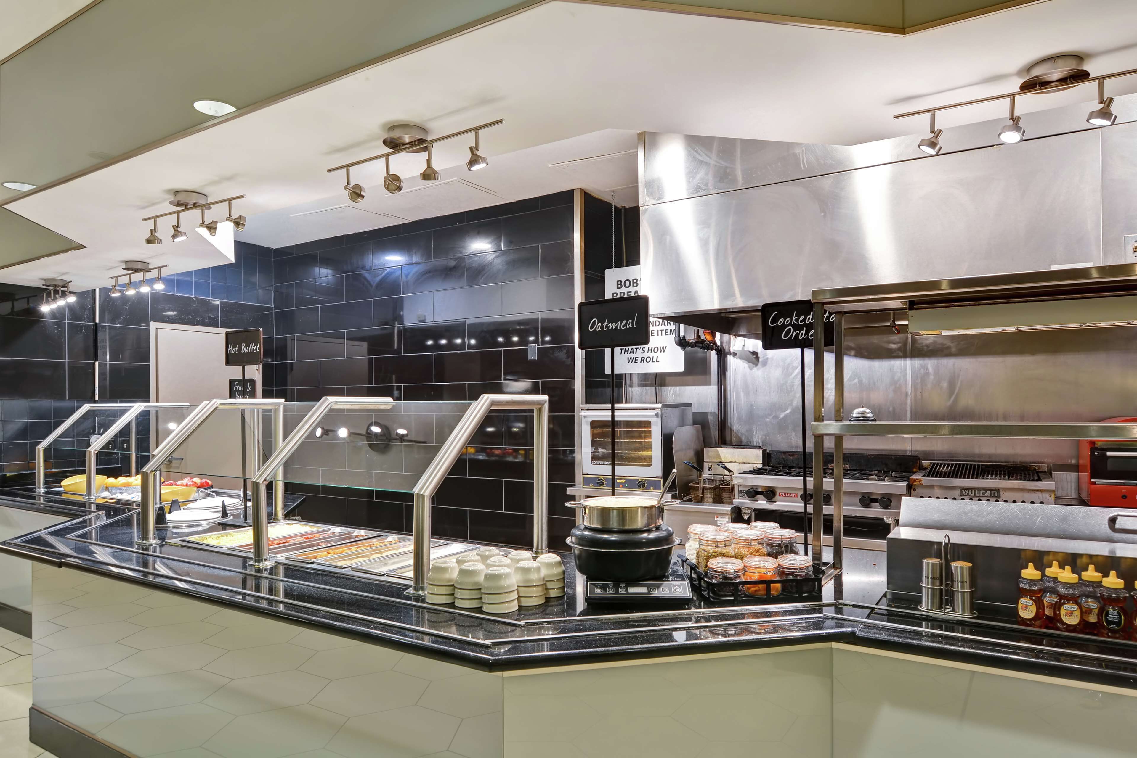 A buffet area with various food items and a hot buffet sign.