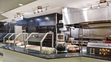 A buffet area with various food items and a hot buffet sign.
