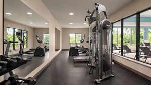 A modern gym with cardio machines, free weights, and a large mirror. - Holiday Inn Express Morgantown by IHG (Morgantown)