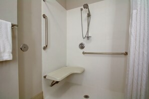 A shower with a grab bar, a handheld showerhead, and a handheld faucet. - Holiday Inn Express Milwaukee North Brown Deer/Mequon by IHG (Milwaukee)