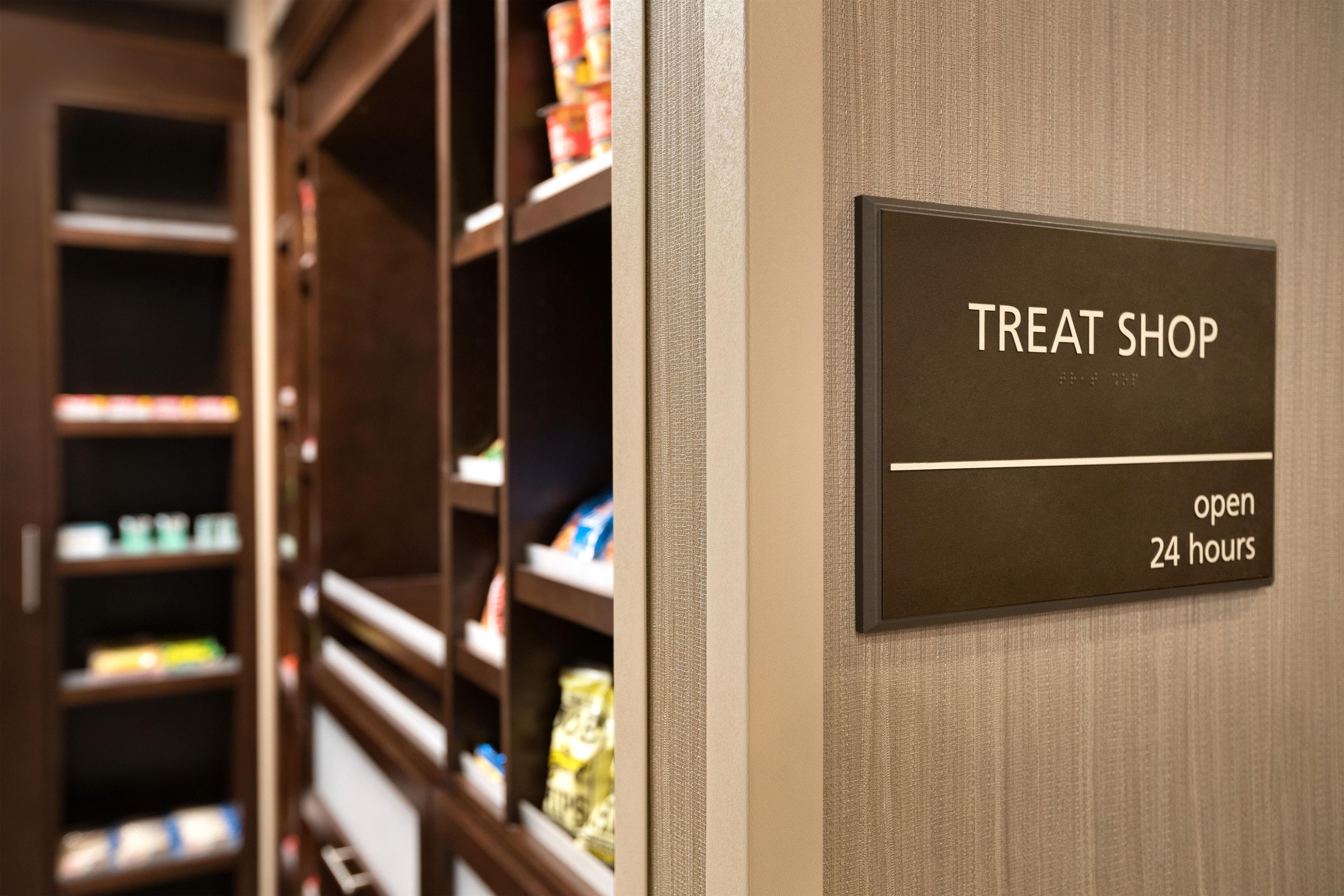 A sign indicating a treat shop open 24 hours.