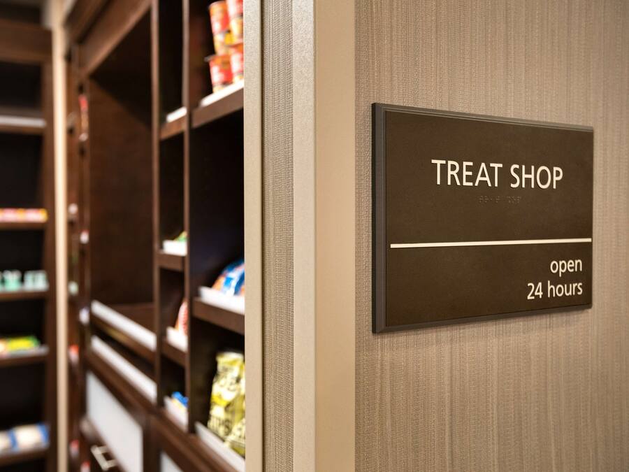 A sign indicating a treat shop open 24 hours.