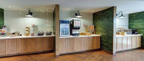 A modern kitchen area with wooden cabinets, a tiled backsplash, and a herringbone wood floor.