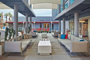 Relax in our outdoor lounge area, surrounded by comfortable sofas and lush greenery.