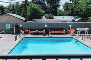 Relax by the pool surrounded by lush surroundings and comfortable lounge chairs.