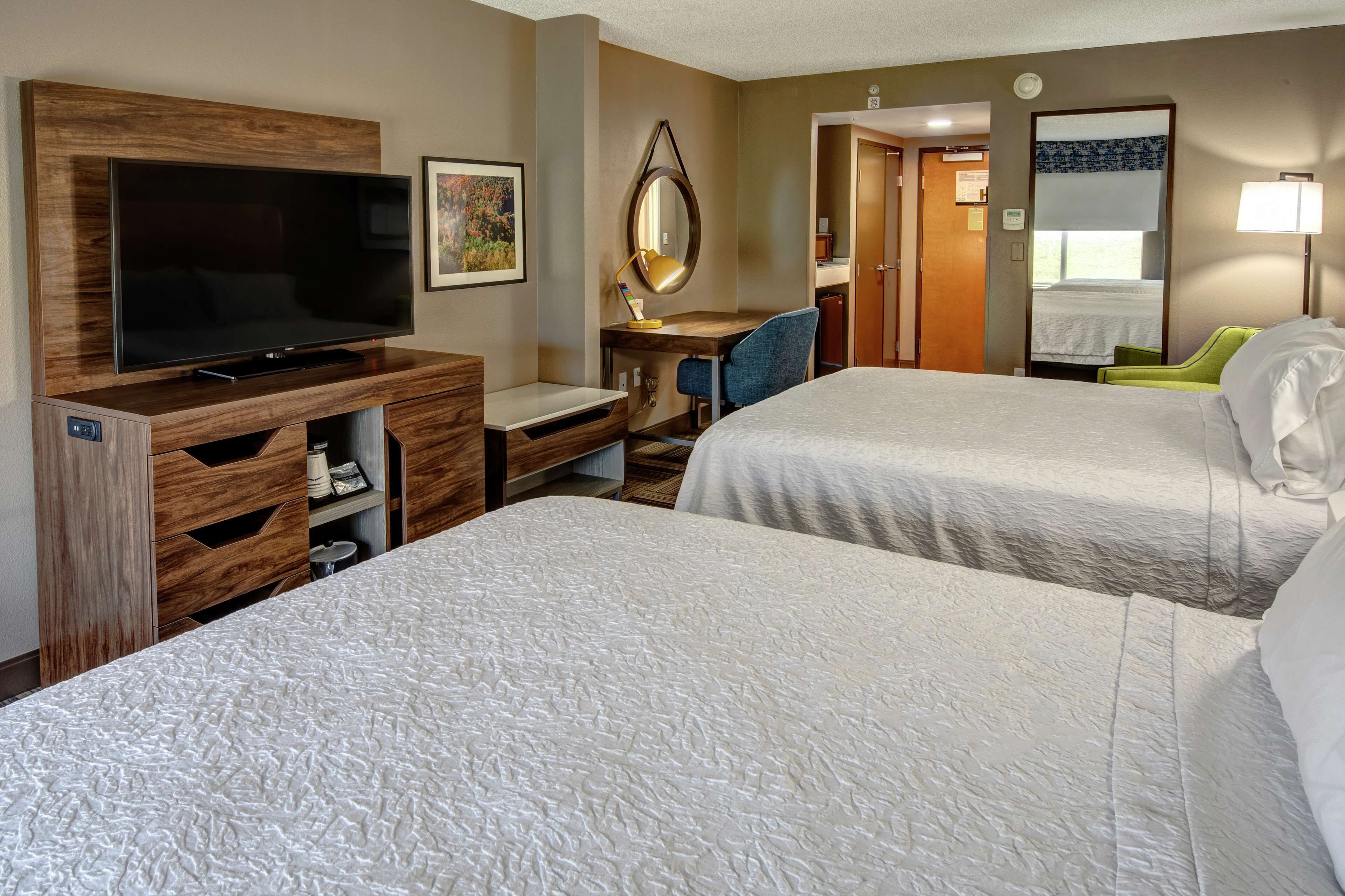 room, 2 queen beds, refrigerator | desk, iron/ironing board, cots/infant beds, free wifi