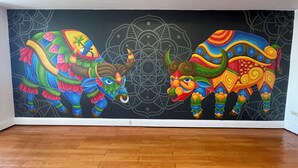 A vibrant mural of two colorful bulls on a wall. - Grand Plaza Hotel (Tamuning)