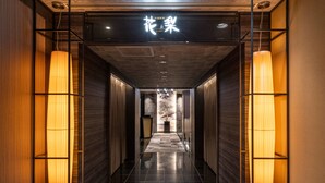 A hallway with a sign reading 'Flower' and a marble wall at the end.
