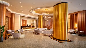 A lobby with a reception desk, seating area, and decorative columns. - Mardhiyyah Hotel and Suites (Shah Alam)