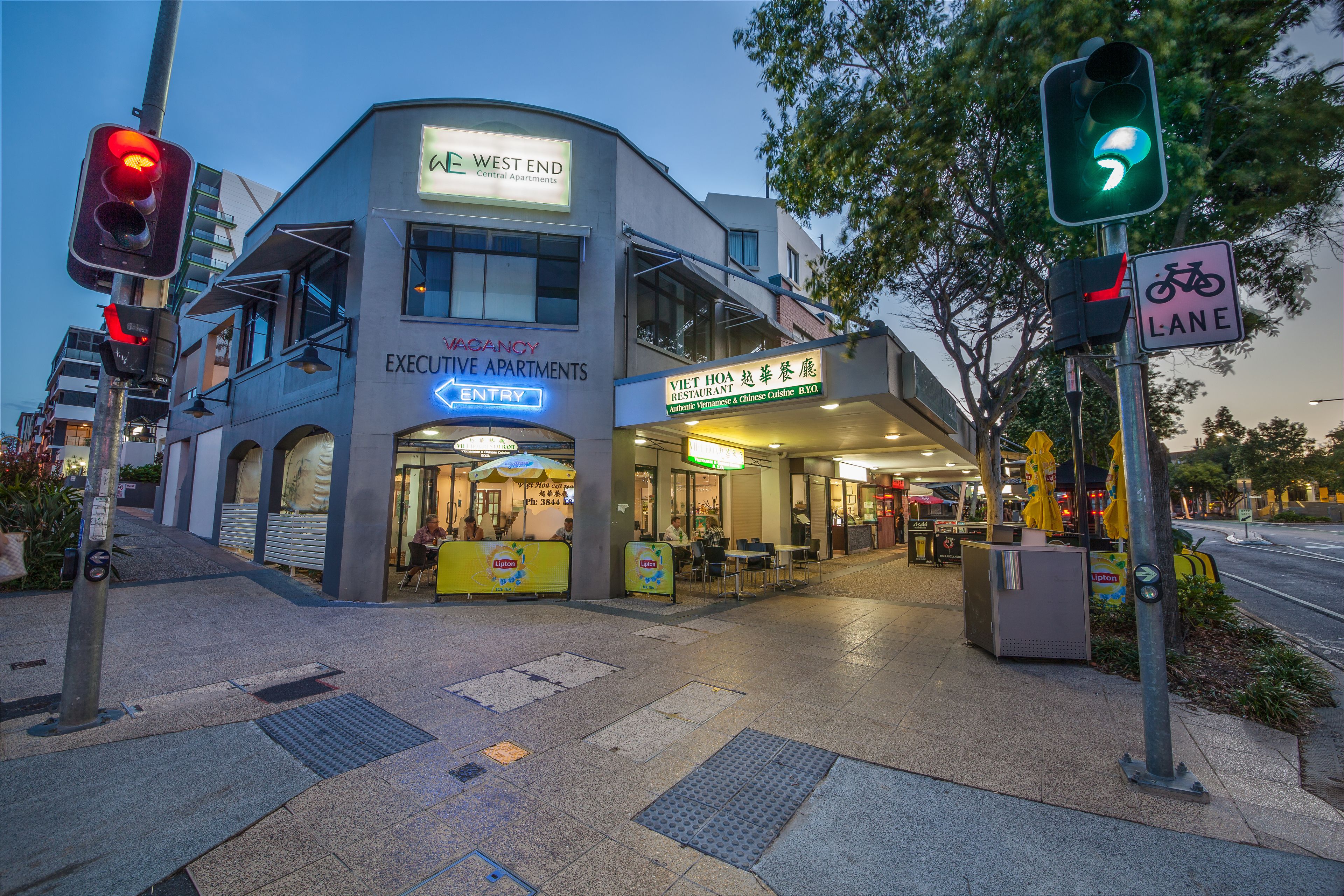 A building with a sign for 'West End Central Apartments' and 'Viet Hoa Overseas Chinese Cuisine'.