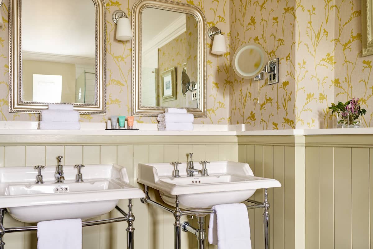 combined shower/bathtub, designer toiletries, hair dryer, bathrobes