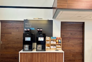 A coffee station with two coffee machines and a sign that says "MUST HAVE COFFEE." - Holiday Inn Express Hotel & Suites SeaTac by IHG (SeaTac)