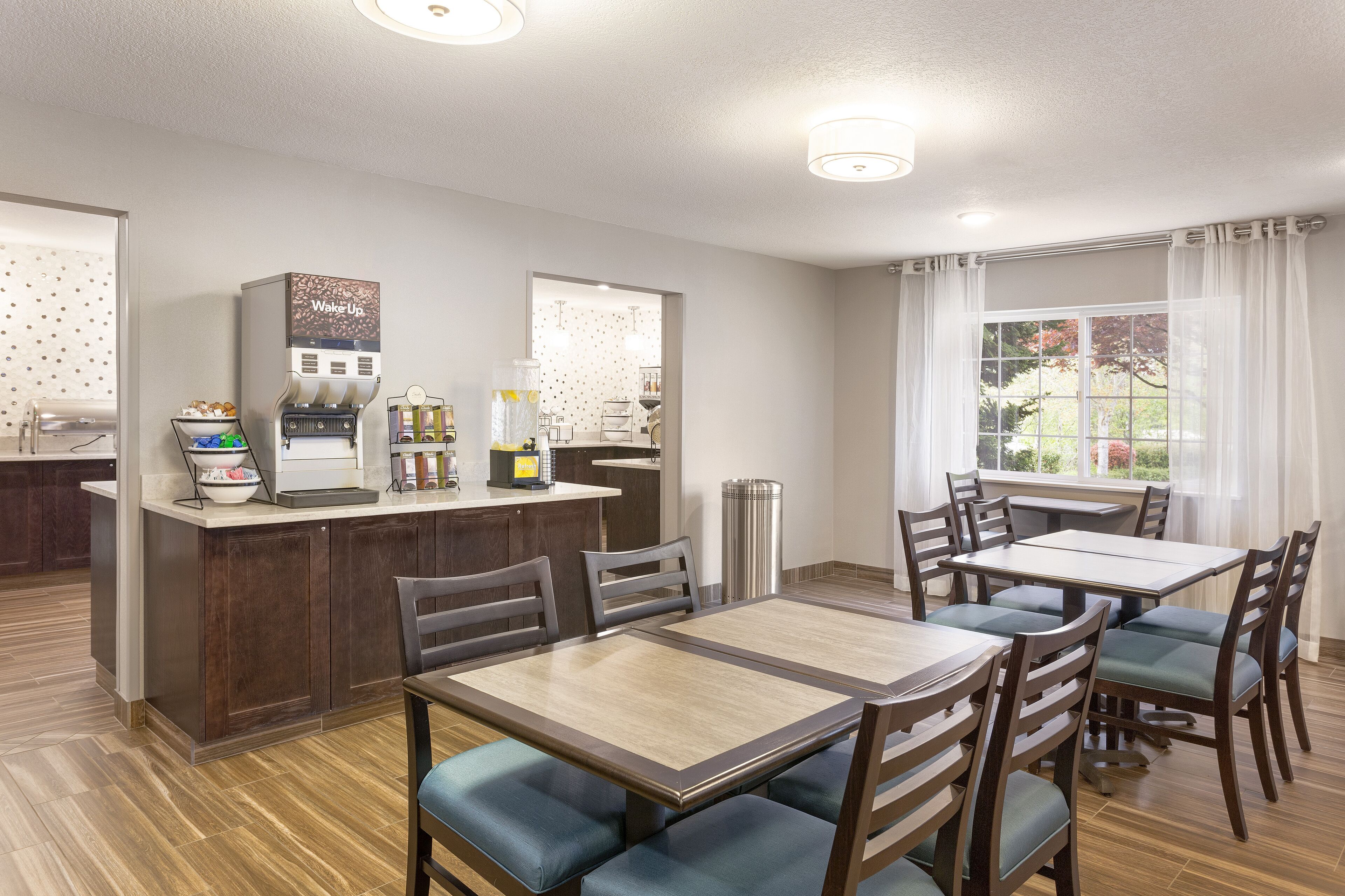 A dining area with a central island, chairs, and a table.