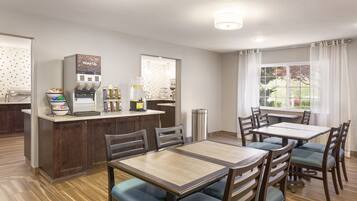 A dining area with a central island, chairs, and a table.