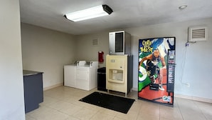 A laundry room with a washing machine, dryer, and ice dispenser.