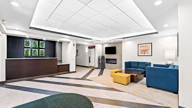 A modern lobby with a reception desk, seating area, and a fireplace. - Best Western The Inn at Ramsey-Mahwah (Ramsey)