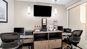 A modern office space with a desk, two chairs, a flat-screen TV, and a coffee station. - Best Western The Inn at Ramsey-Mahwah (Ramsey)