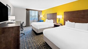 A hotel room with two beds, a desk, a TV, and a window with curtains. - Best Western The Inn at Ramsey-Mahwah (Ramsey)