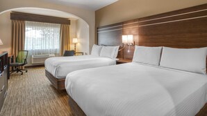 A hotel room with two beds, a desk, a chair, a lamp, and a window with curtains. - Best Western Champions Forest Inn and Suites (Houston)