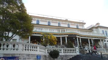 The Carrington Hotel with a grand entrance, a stone wall, and a sign indicating parking for hotel guests and patrons only.