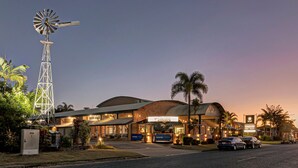 A hotel with a prominent windmill, a curved roof, and a sign that reads "The Mill." - Windmill Motel and Events Centre (Mount Pleasant)
