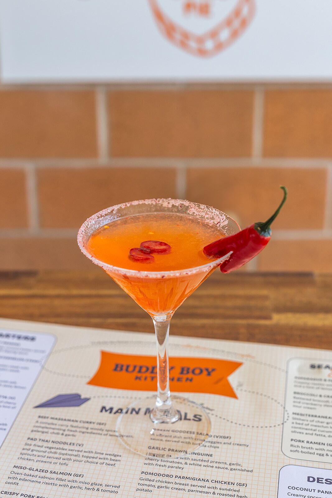 A martini glass with a garnish on a menu.
