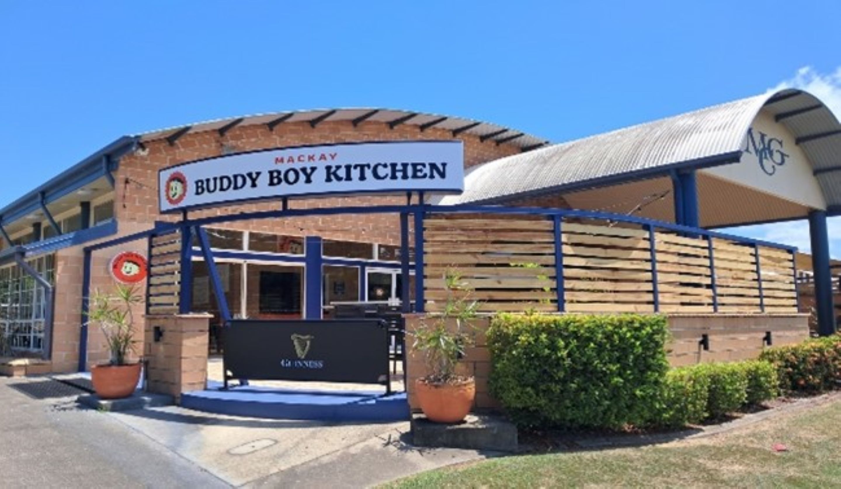 A Buddy Boy Kitchen with a signboard, a logo, and a branded entrance.