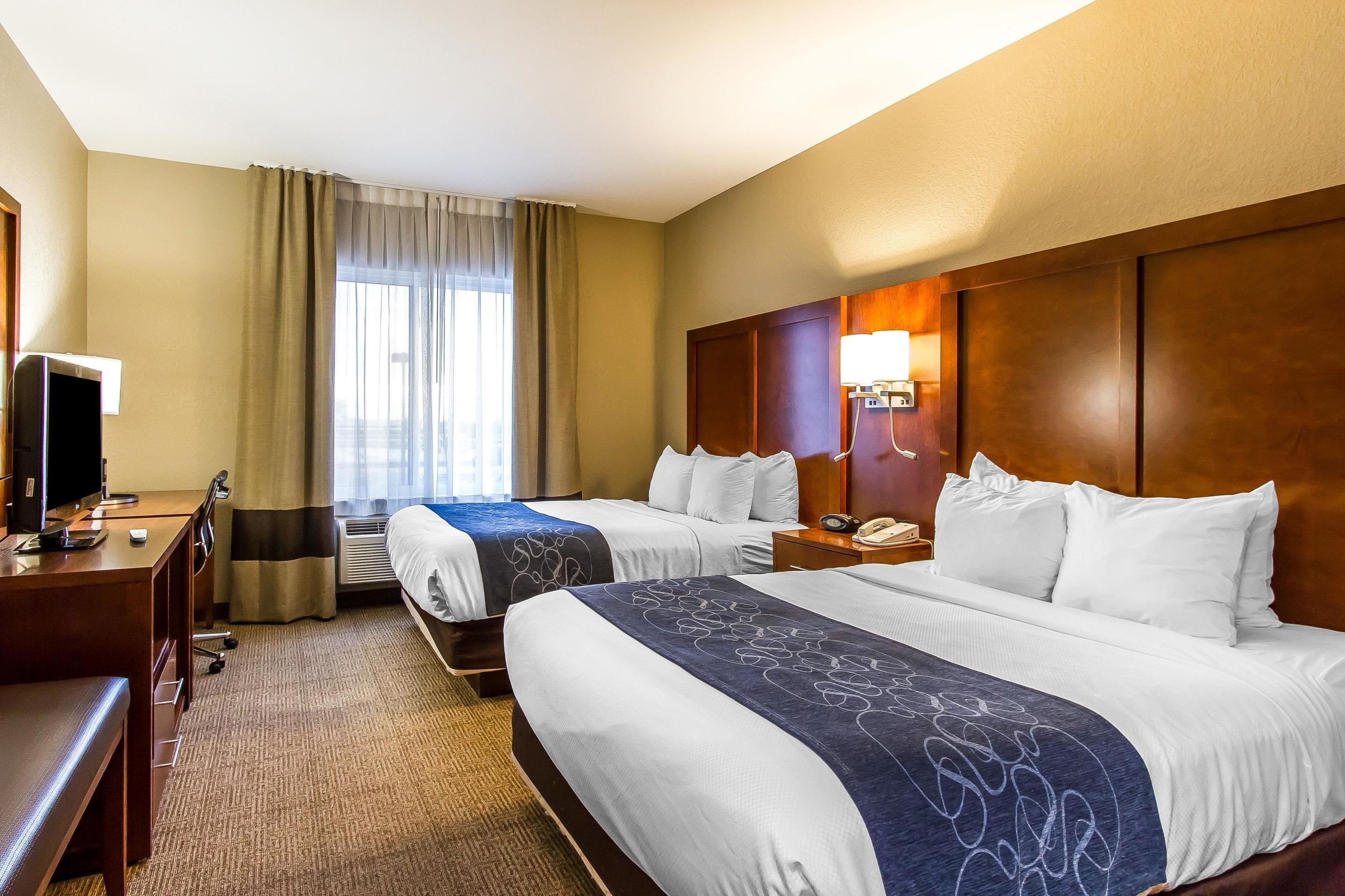 pillow-top beds, desk, laptop workspace, blackout curtains